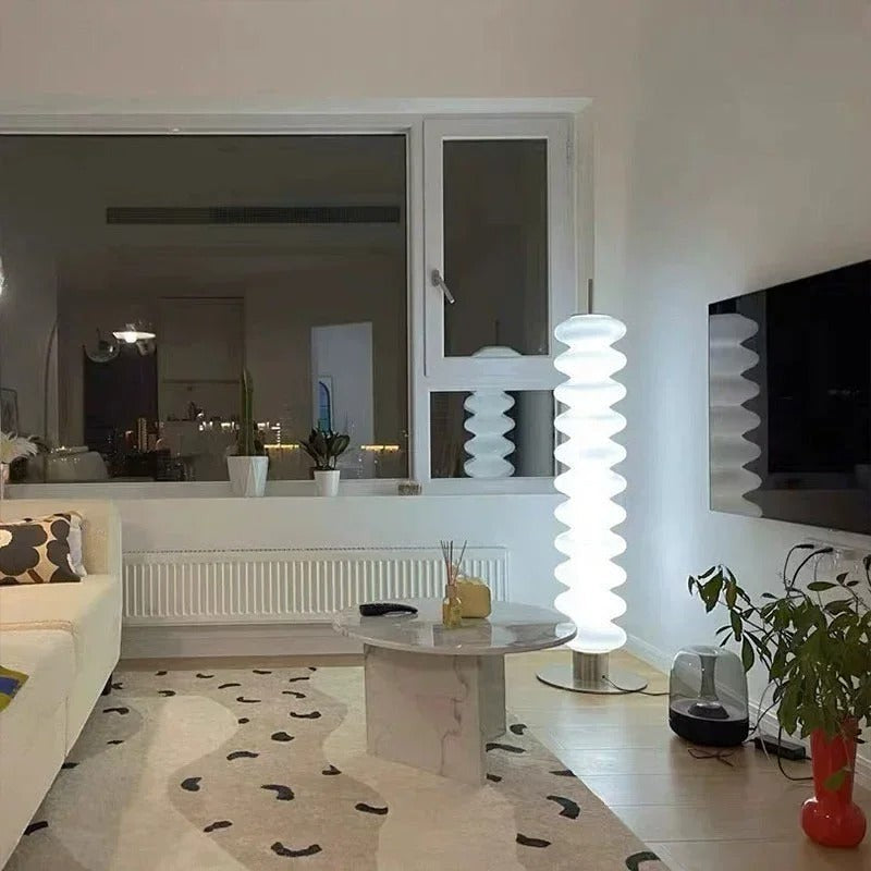 Lampadaire design Dimoree en acrylique blanc diffusant une lumière douce dans un salon contemporain