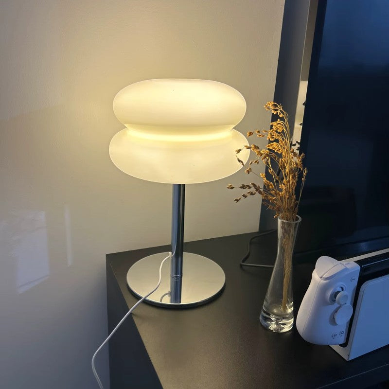 Lampe de table Dimoree en verre soufflé blanc avec pied en métal chromé, design moderne et organique.