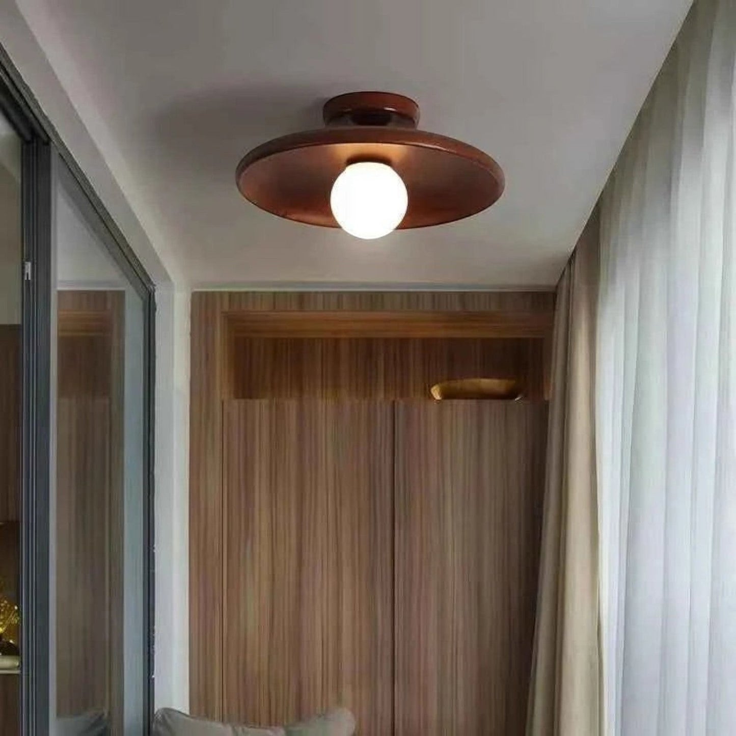 Plafonnier Dimoree moderne en chêne noisette avec globe lumineux blanc installé au plafond d'un couloir élégant