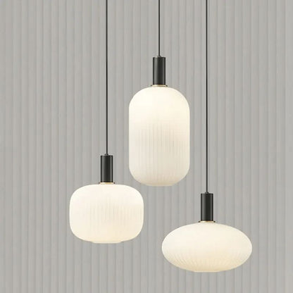 Suspension lumineuse Dimoree moderne avec abat-jours en verre dépoli nervuré et finitions en métal noir mat.