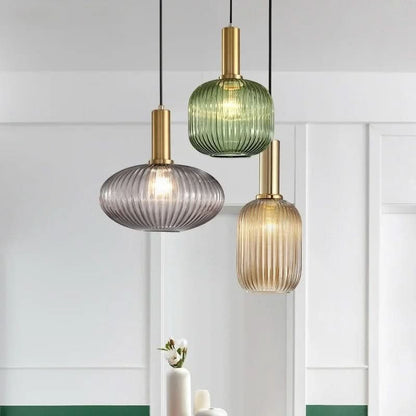 Suspension lumineuse Dimoree en verre nervuré coloré et métal doré brossé pour un éclairage intérieur élégant.